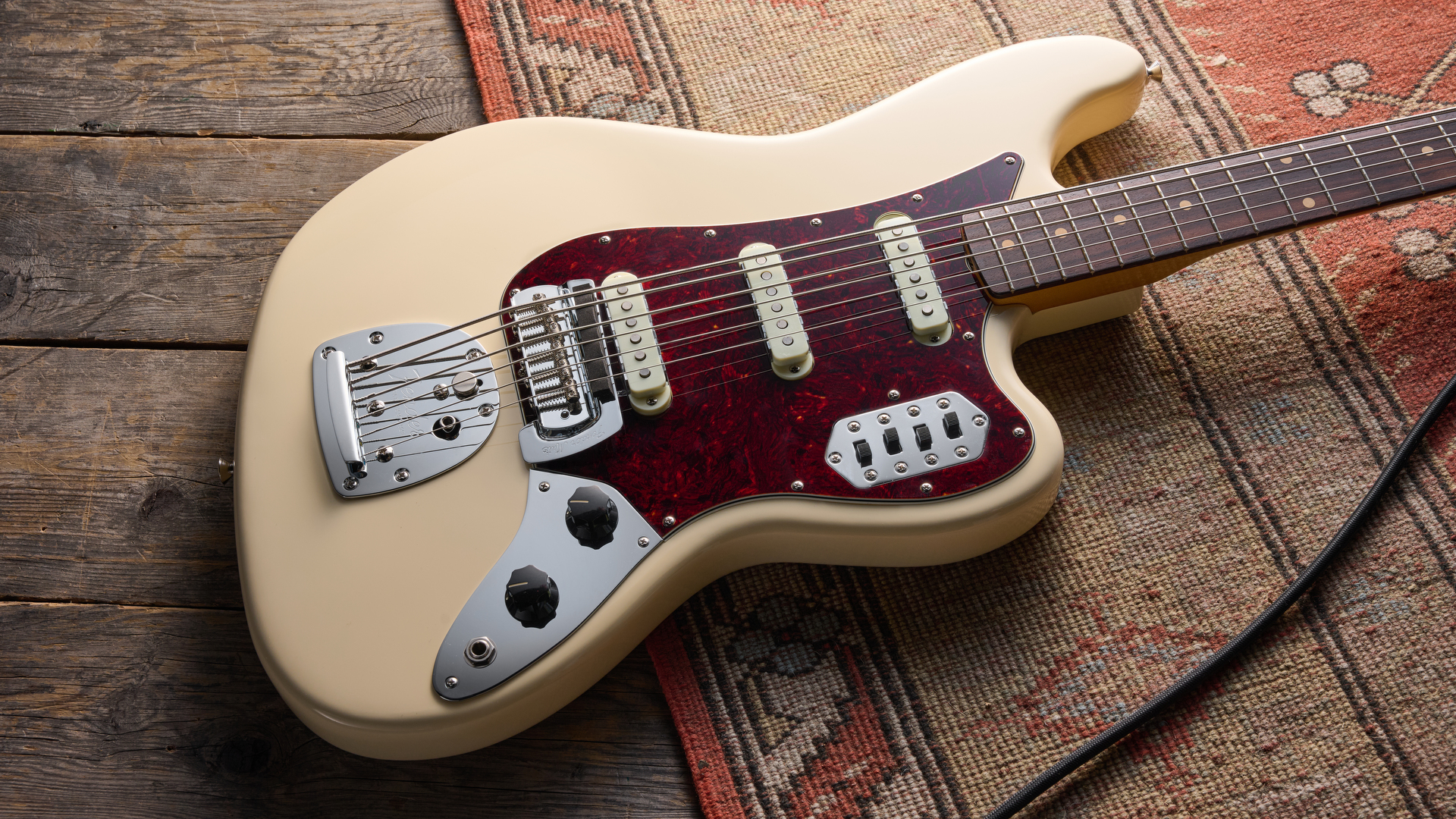 Fender Vintera III ‌Early '60s Bass VI in Olympic White with⁣ red tortoiseshell pickguard.