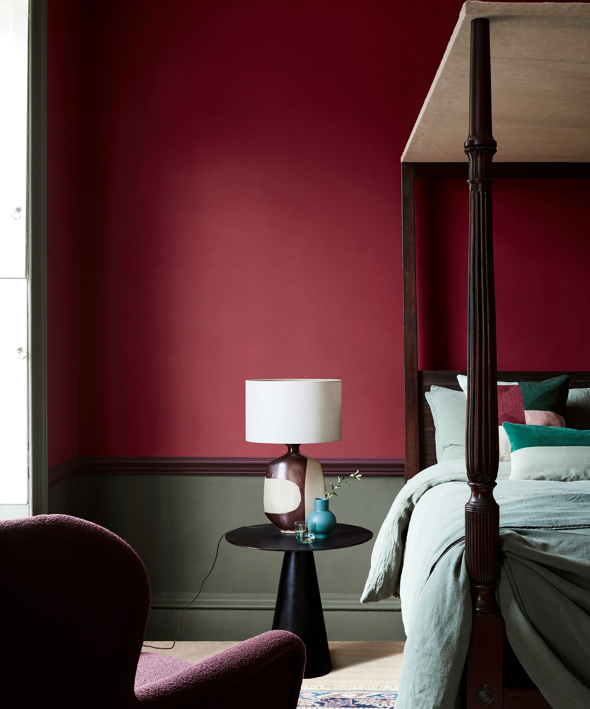 Bedroom with wall painted red at the top and green below the dado rail