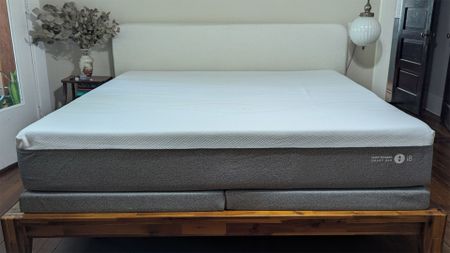 Grey and white Sleep Number i8 smart mattress on wooden bedframe 