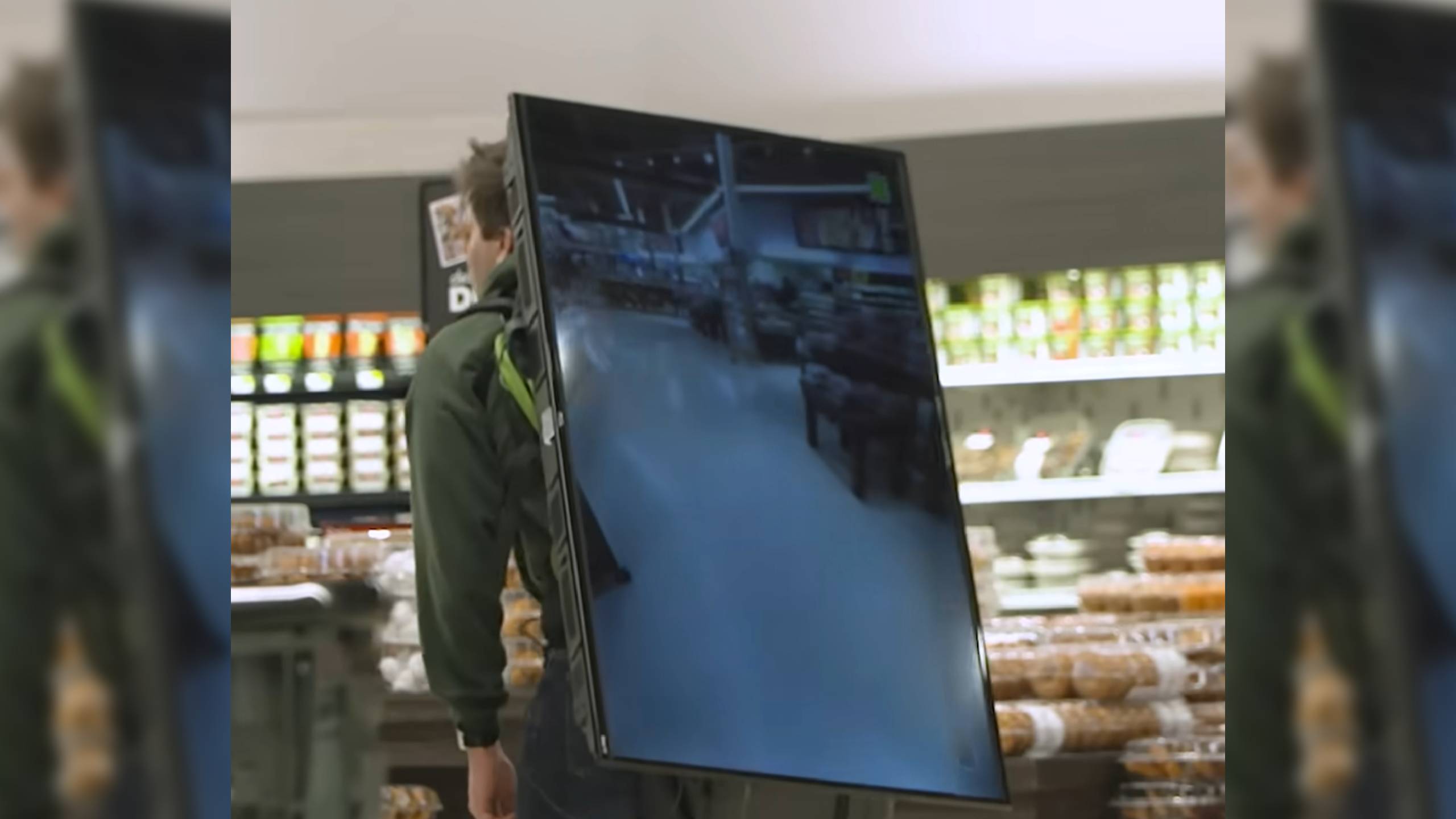 Chris the Producer with a TV strapped on his back to avoid camera surveillance.