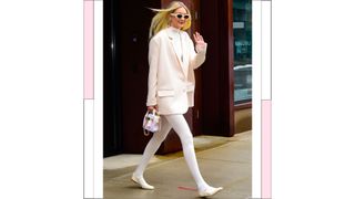 Gigi Hadid pictured wearing white tights and white pumps, with a white blazer while out in NYC
