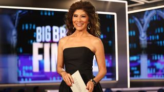 Julie on the Big Brother stage on finale night. She's smiling and wearing a black dress. 