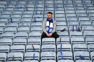LEICESTER, ENGLAND - MAY 28: A Leicester City fan looks dejected after their sides defeat, resulting in their relegation to the Championship during the Premier League match between Leicester City and West Ham United at The King Power Stadium on May 28, 2023 in Leicester, England. (Photo by Michael Regan/Getty Images)