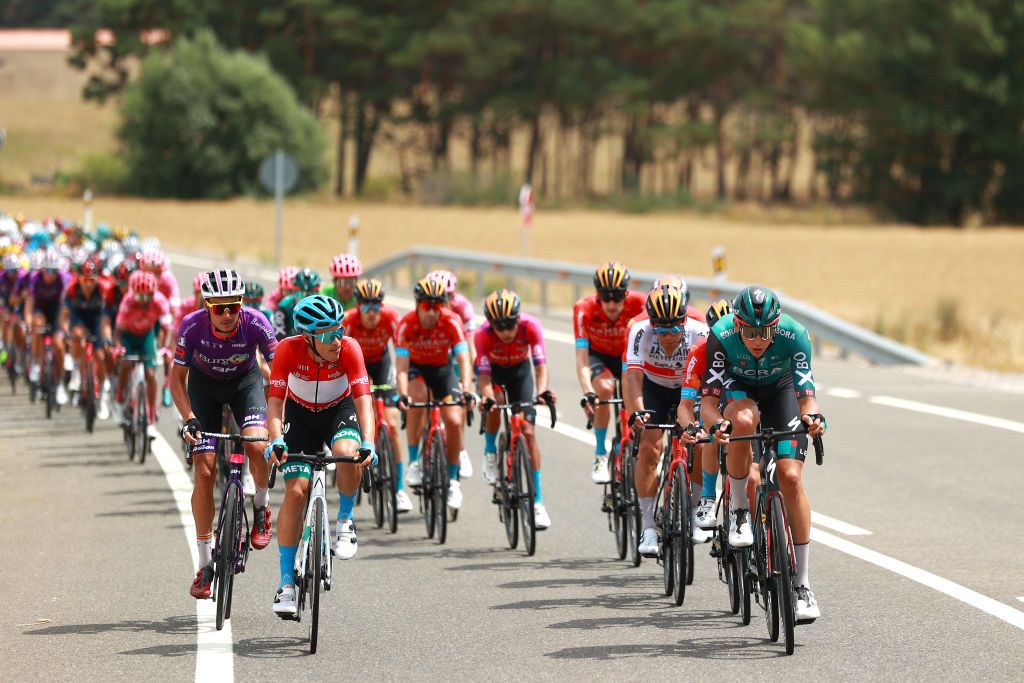 VILLADIEGO SPAIN AUGUST 03 Jess Ezquerra Muela of Spain and Team Burgos BH and Diego Pablo Sevilla of Spain and EoloKometa Cycling Team Red Mountain Jersey in the breakaway are gobbled up by Patrick Gamper of Austria and Team Bora Hansgrohe and peloton during the 44th Vuelta a Burgos 2022a Stage 2 a 158km stage from Vivar del Cid to Villadiego on August 03 2022 in Villadiego Spain Photo by Gonzalo Arroyo MorenoGetty Images