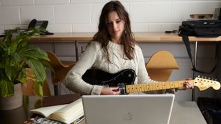 Guitarist with guitar and laptop