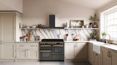 A white kitchen with a marble backsplash, a black oven, and decorative items on the shelves