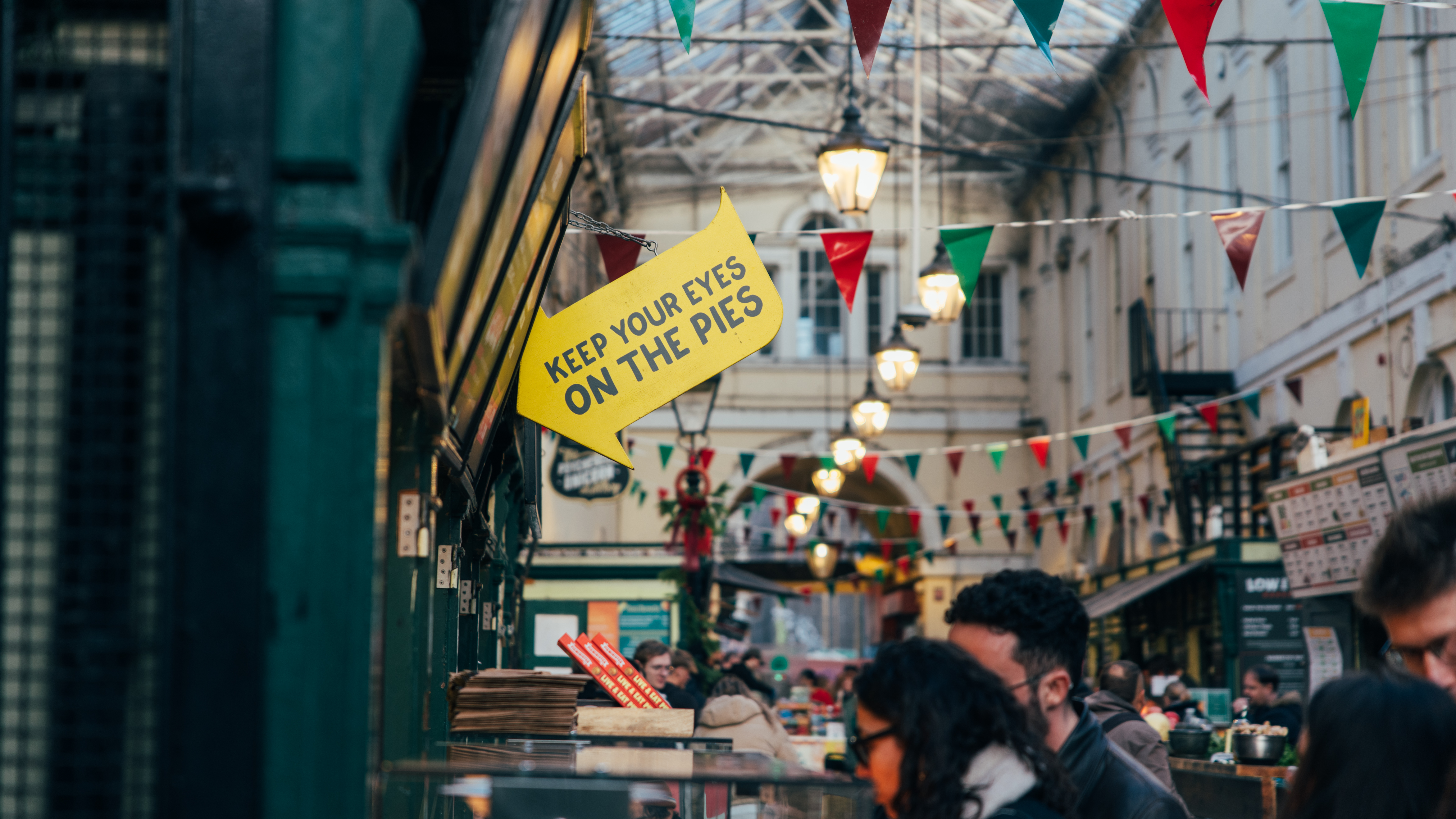 Shot of St Nick's market in Bristol, UK, showing various stands and signs