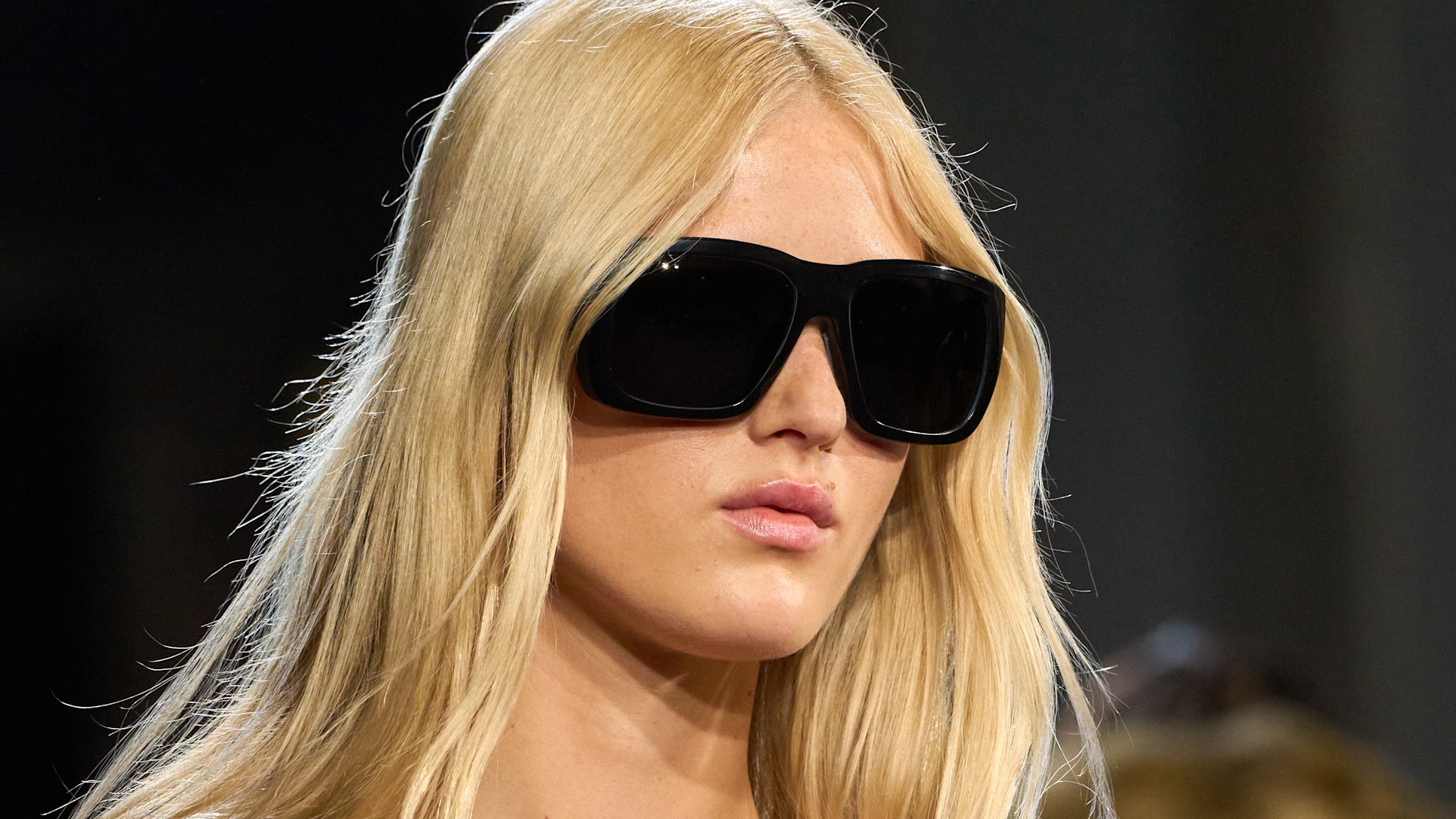 woman with blonde hair and sunglasses