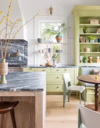 Green kitchen with grey marble countertops
