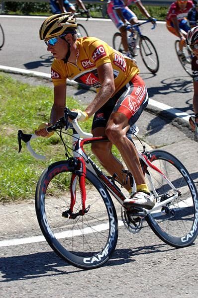 Vladimir Efimkin sits in the peloton in the golden jersey