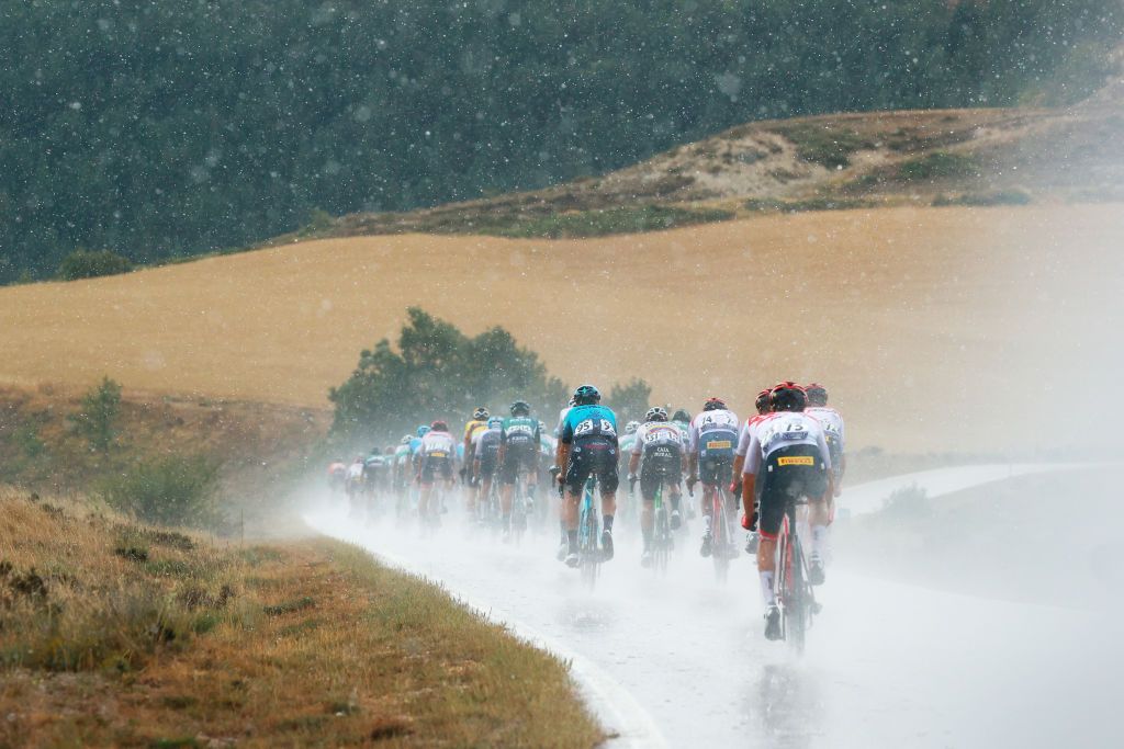 VILLADIEGO SPAIN AUGUST 03 A general view of the peloton passing through a landscape while a storm rages during the 44th Vuelta a Burgos 2022a Stage 2 a 158km stage from Vivar del Cid to Villadiego on August 03 2022 in Villadiego Spain Photo by Gonzalo Arroyo MorenoGetty Images