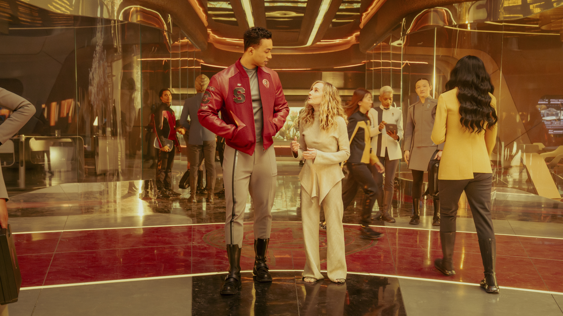 people in futuristic clothing in a brightly lit room