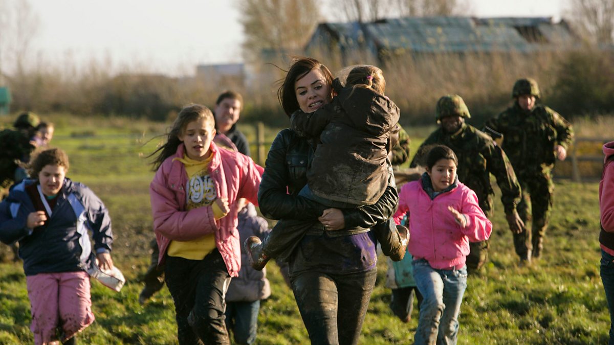 Screenshot from the 2009 mini-series Torchwood: Children of Earth showing Gwen Cooper rescuing a group of children, running through a field.