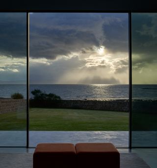 View of the coast under a cloudy sky from inside House for a Chemist