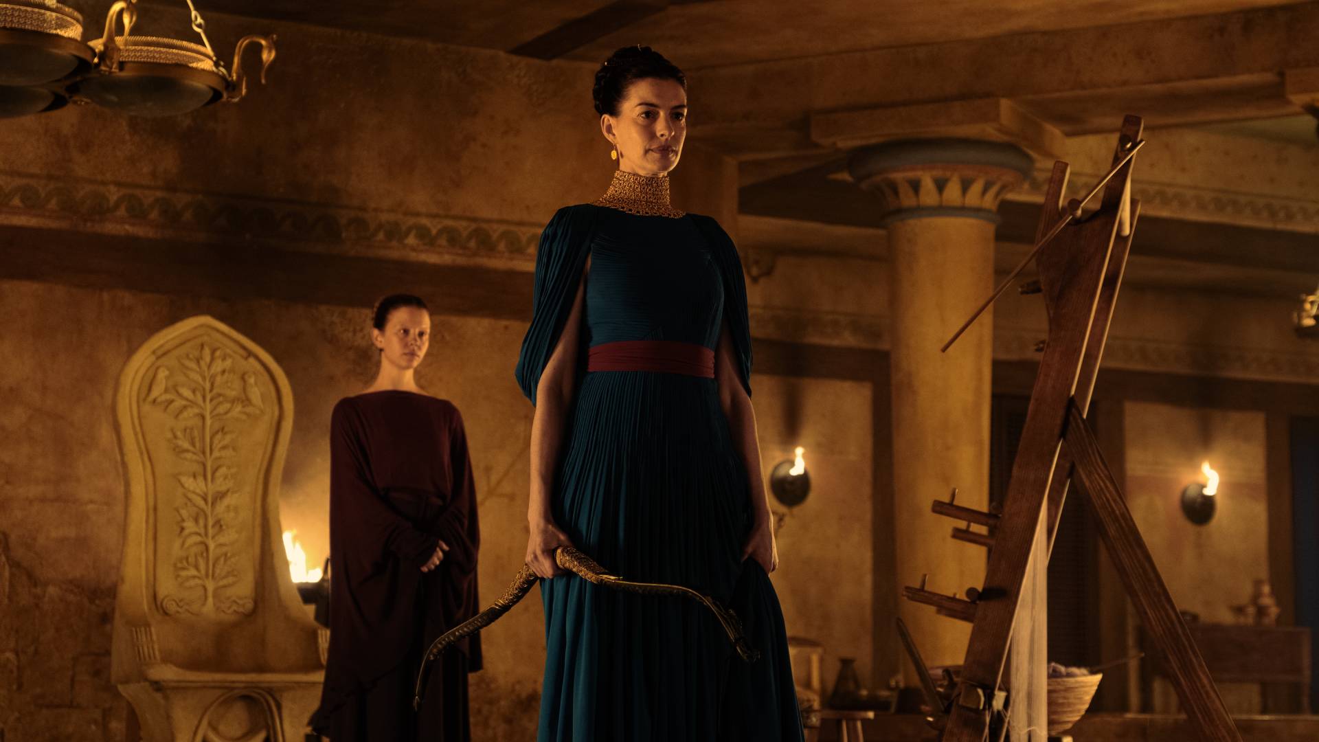 Anne Hathaway as Penelope holding a bow in The Odyssey