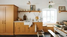 rustic kitchen with white walls and dark yellow cabinets