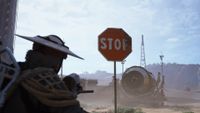 A raider points their gun at a stop sign in Arc Raiders.