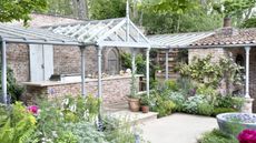 An outdoor kitchen and eating area inside a kitchen garden at the Chelsea Flower Show