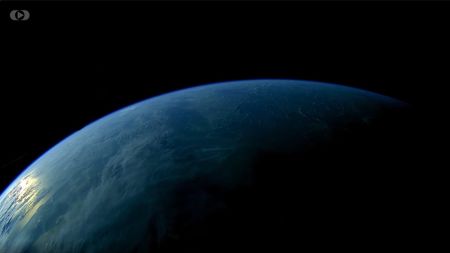 a view of blue Earth rising from below against black shadowy space.