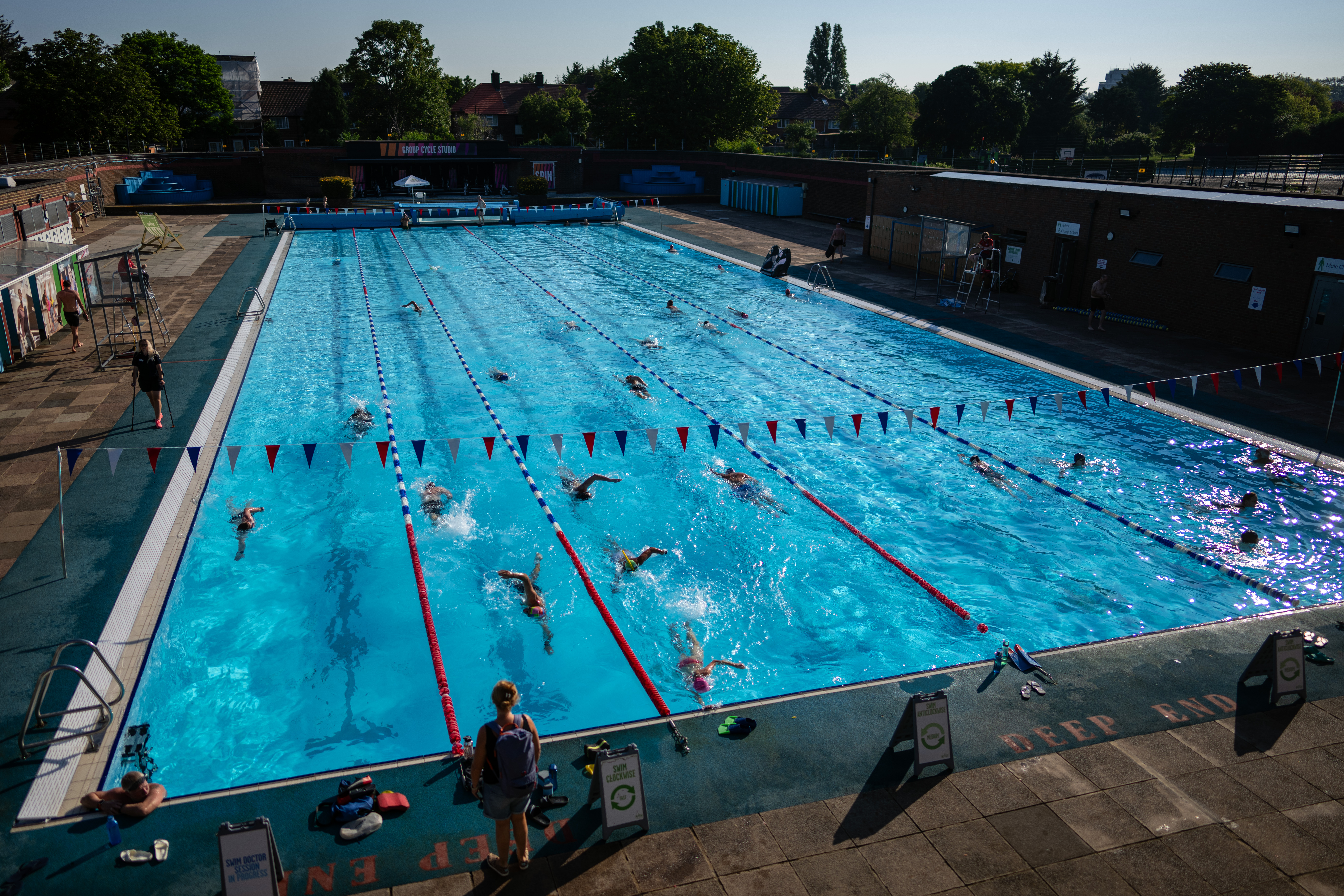 People enjoy a swim at Charlton Lido in London during summer when temperatures reaching the low 30s
