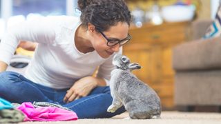 Woman and mouse touching noses