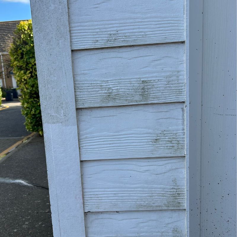 Pressure washer cleaning white cladding before - dirty