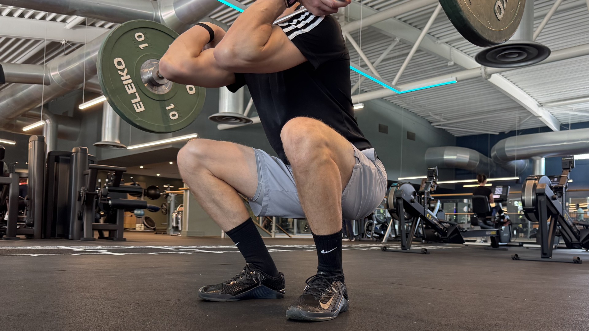Black Nike shoe worn by man in gym