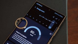 The gold Samsung Galaxy Ring with the Galaxy Wearables app showing the energy score