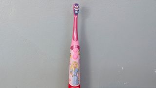 Colgate Kids Battery Powered electric toothbrush being tested by our reviewer