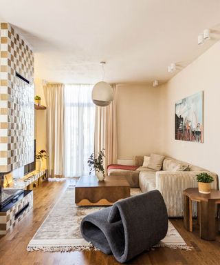 living room with tiled modern fireplace and gray statement chair