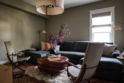 olive green living room with brown leather coffee table