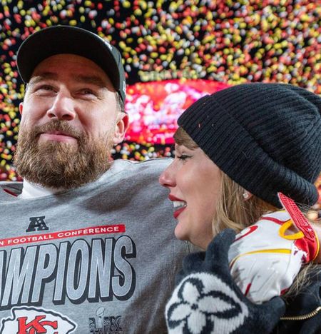 Travis Kelce wearing a gray t-shirt putting his arm around Taylor Swift with confetti falling behind them at the AFC Championships 2025