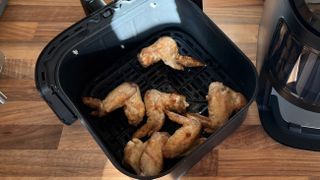 Chicken Wings coooked in the frying basket of the Dreo 6-Quart Air Fryer