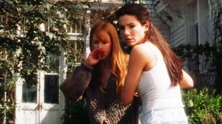 Nicole Kidman and Sandra Bullock in Practical Magic looking at something.