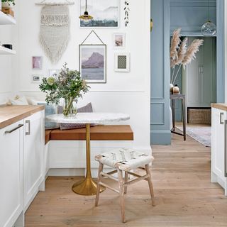 A dining nook with blue hallway beyond