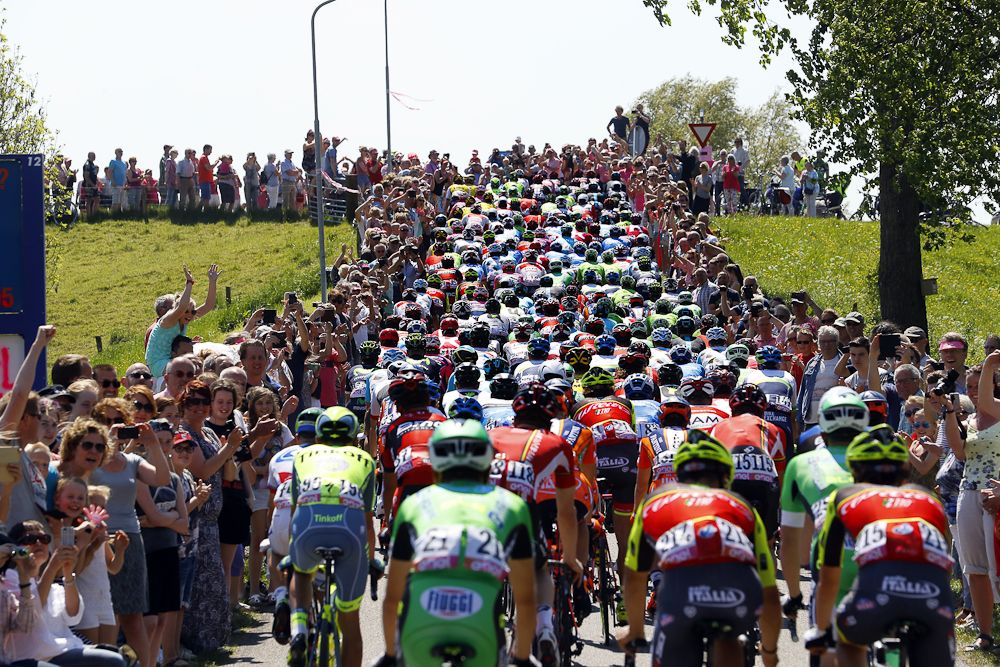 Fans and riders pack the roads and roadside during stage 3 at the Giro.