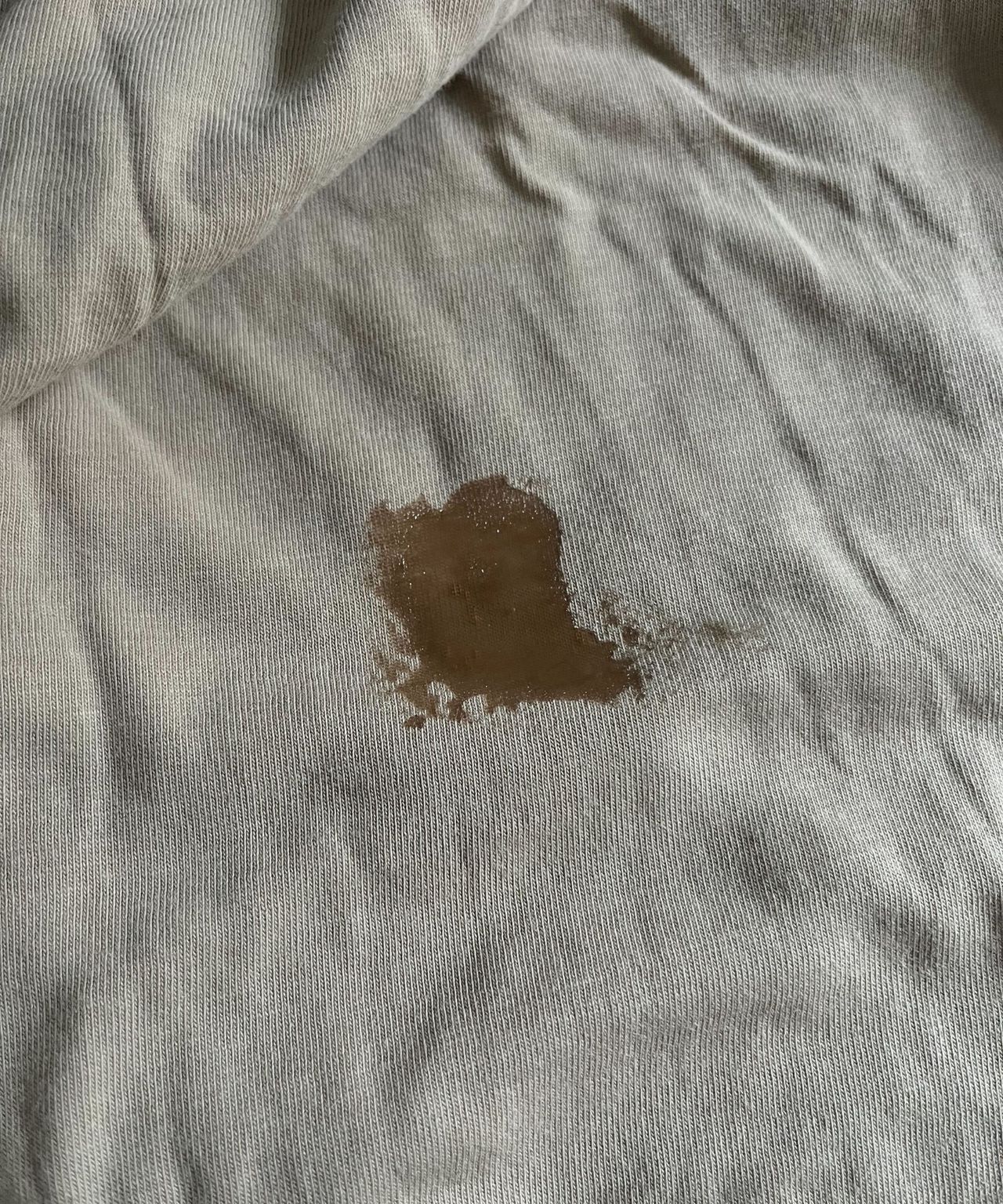 A wet patch over some old blood stains on a beige top