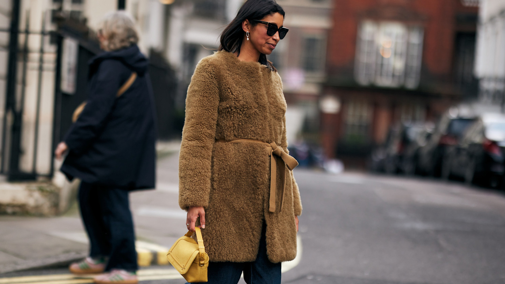 a woman wearing a furry winter coat in street style