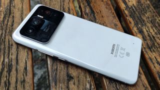 Baksidan av en Xiaomi Mi 11 Ultra som ligger på en träbänk