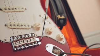 Close up of the bridge and electronics on a Fender Stratocaster