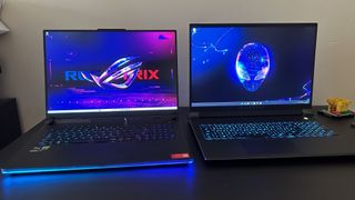 Alienware M18 and Asus ROG Strix Scar 18 side by side on a black table