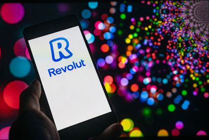 The logo of Revolut online banking is being displayed on a smartphone in a photo illustration