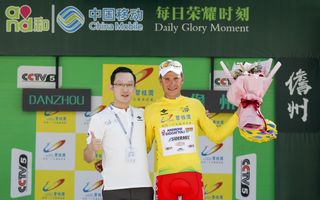 Fausto Masnada pulls on the yellow jersey as overall winner of the 2018 Tour of Hainan