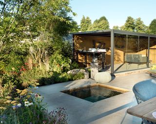 modern paved patio with a small plunge pool in the center and a covered seating area