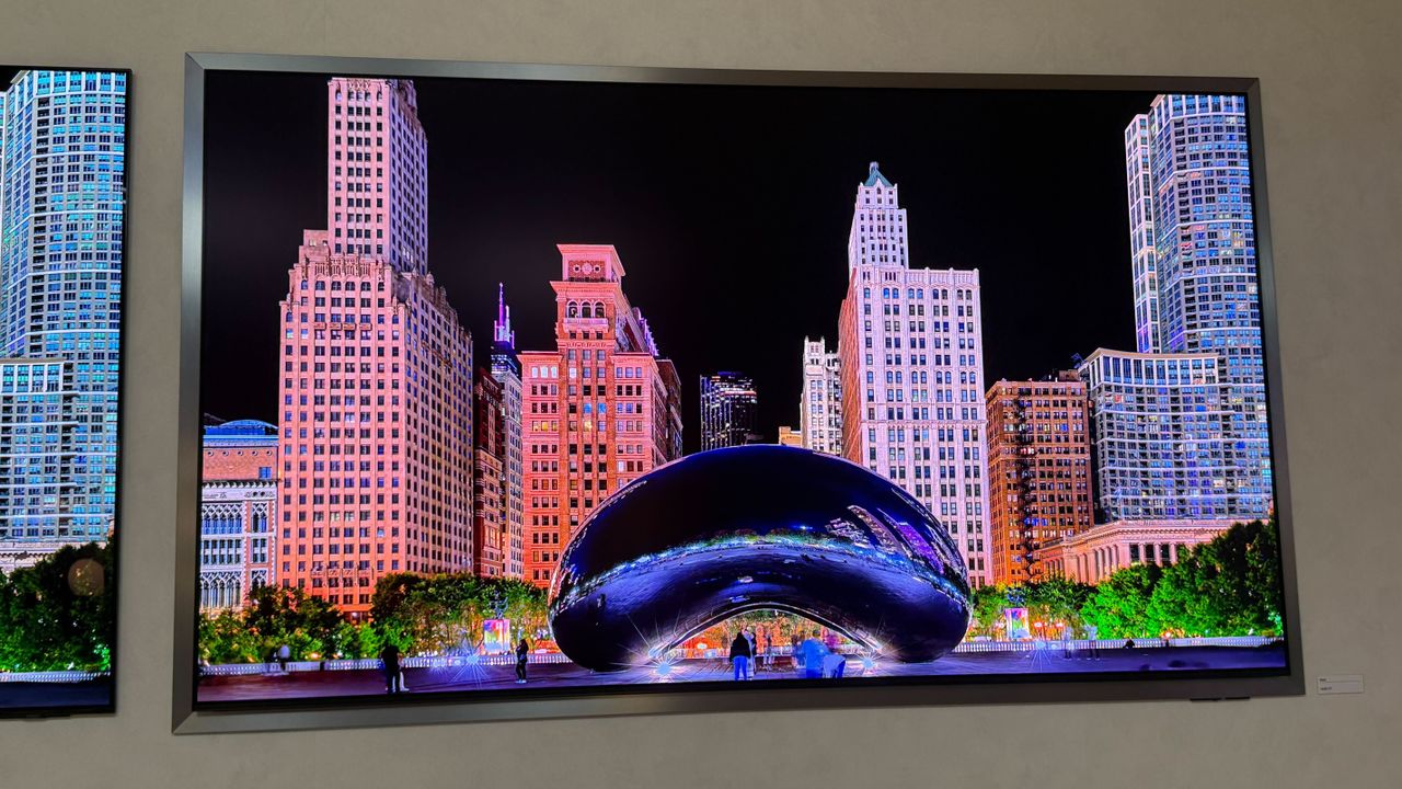 A wall mounted Samsung S95H showing stock footage of Las Vegas at night time