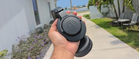 The Audio-Technica ATH-M20xBT being held in hand