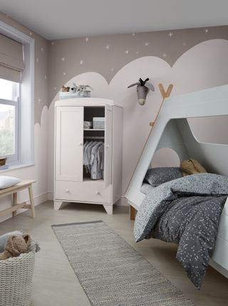 Crown Cloud Burst, the best grey paint for kids' bedrooms, in a lovely pink and grey kid's room with a bed and a freestanding wardrobe