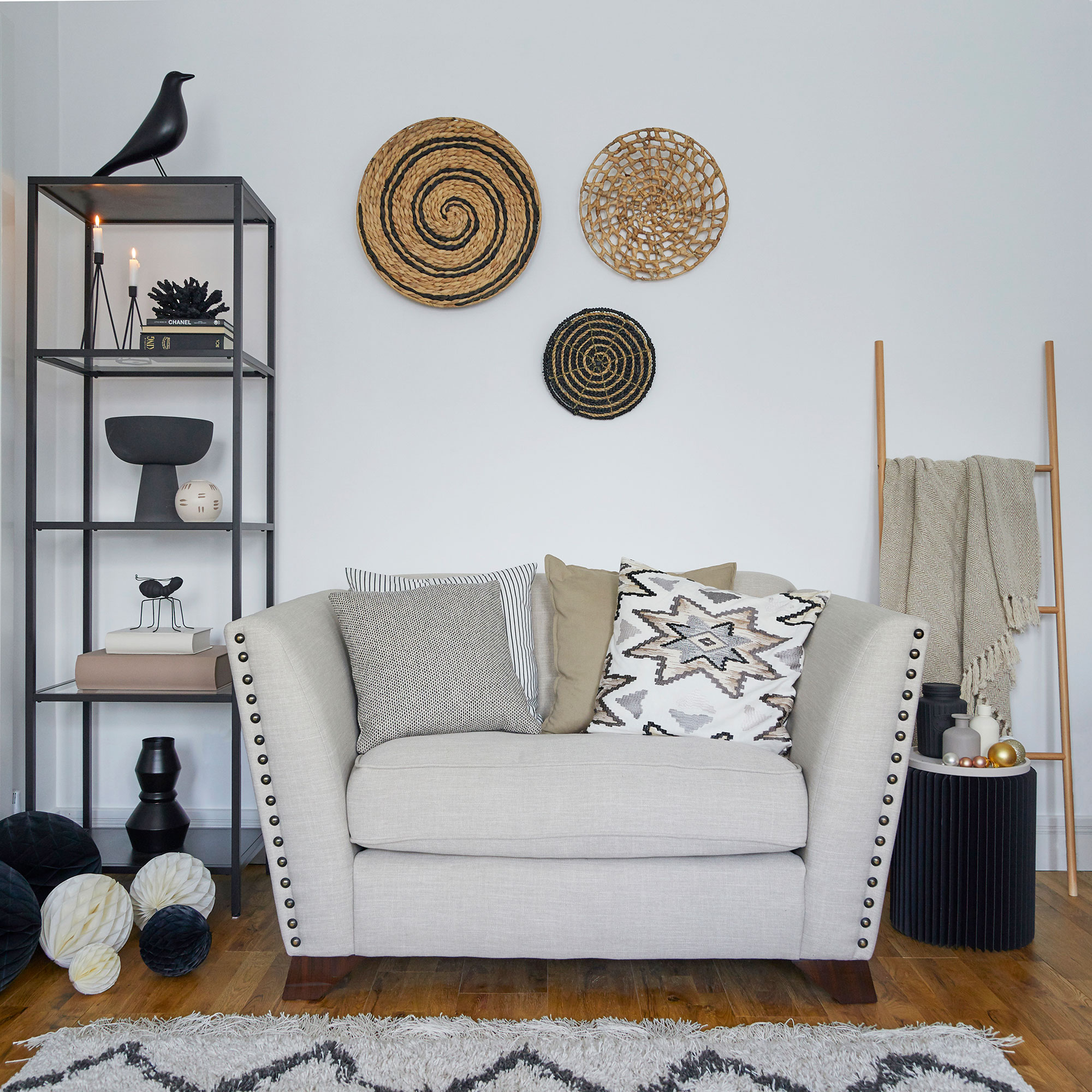 neutral living room with loveseat and open shelving