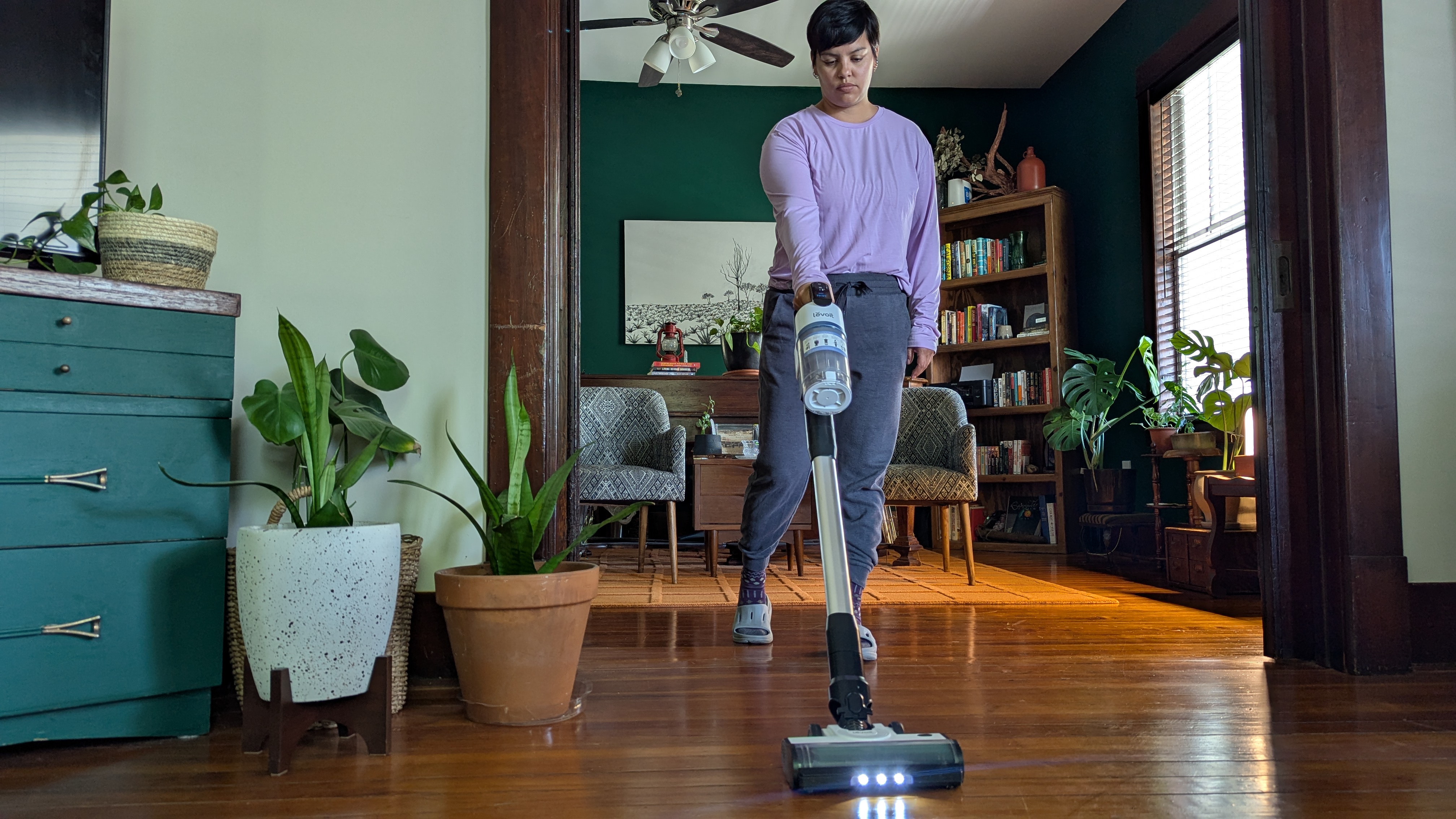 Reviewer using Levoit Aero vacuum to clean her living space