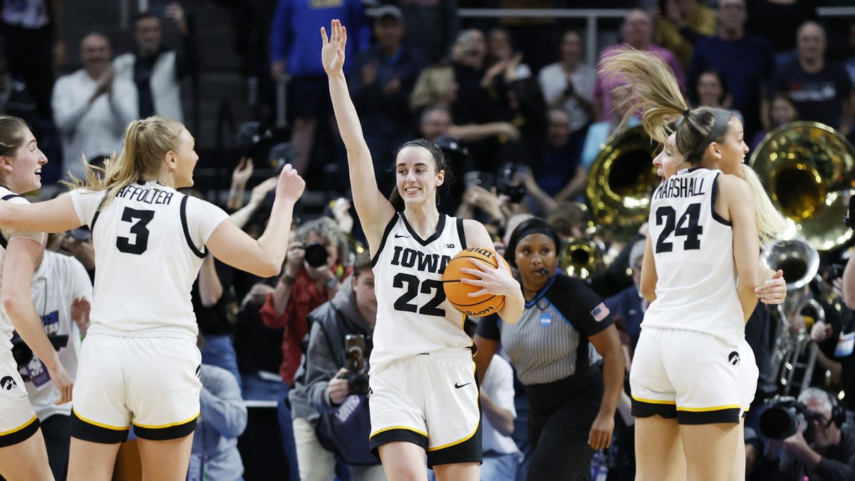 Caitlin Clark #22 of the Iowa Hawkeyes and her teammates celebrate after beating the LSU Tigers 94-87 for a place in the Final Four 2024 at March Madness